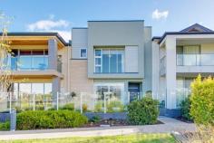  7 Tidsworth Lane Lightsview SA 5085 Perfectly positioned this ultra-urban community of sustainable, innovative, and sleek executive style living with all the required elements of a desirable estate. Set over two spacious levels this beautifully presented home overlooks lush parklands, tennis courts and a playground with the lake at the end of a Private Lane. Relish the opportunity for a ‘turn key’ lifestyle in this sought after suburb only moments to Northgate Shopping Village and 8 short kilometers from Adelaide’s CBD. Lightsview is a vision of community, lifestyle with a social and environmental conscience this home is no exception and offers a fantastic opportunity for buyers and investors alike. Featuring an open plan design to the lower level of living, kitchen and dining room taking advantage of gorgeous vistas over the park and opening out through sliding glass doors to the front gardens. The stunning parklands make for the perfect place to kick a football or engage in some cricket with the neighbors- arguable the most enviable backyard in Adelaide! The kitchen is sure to impress the home cook or entertainer with a plethora of features including island bench, spacious walk in pantry, quality stainless steel 900w cooker and clear glass splashback with views to the central entertainer’s courtyard. Spacious accommodation to the upper level includes three generous bedrooms perfect for family or guests with all rooms complete with built in robe storage and the stunning Master Suite with ‘his’ and ‘her’ robe and luxe ensuite with double vanity. Completing the upper level is a second living area, study nook and main bathroom with bath. Added Features to love; • Lower level Powder room plus additional powder room to the upper level • Floating Timber floorboards to the lower level living areas • Multi zoned ducted reverse cycle air-conditioning throughout • Double lock up garage with direct access to the internals • Ample storage throughout • Quality schooling including Cedar College, St Martins and Roma Mitchell Secondary School • Only minutes to Northgate Shopping Centre and Greenacres Shopping Centre • Easy access to public transport including the Klemzig Interchange.. 