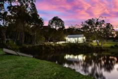  2000 Peats Ridge Road Calga NSW 2250 Set against a stunning natural rock wall backdrop this property is a green crucible of 6 cleared and extensively pasture improved acres, fenced, irrigated and landscaped for those seeking the peace and tranquillity of a private rural lifestyle just approximately 30 minutes’ drive to Wahroonga and the M1. The property offers direct access to horse riding trails and to Glenworth Valley. The owners have laboured intensively at developing the landscape to create a beautiful, green blanket of quality, perennial pasture. There is a river sand arena at the top of the property, with excellent drainage and two dams provide great water for irrigation and stock. A central main dam complete with cascading waterfall makes a stunning feature, overviewed by the delightfully presented and recently renovated, double brick, 3 bedroom and study home, featuring large central living areas with polished concrete floors, high ceilings, central fireplace and beautifully presented outdoor areas. There is central air-conditioning and 2 tastefully renovated bathrooms providing a high degree of comfort. Views from the renovated kitchen and other areas are extensive across all of the property. Landscaping around the home has been carefully designed and constructed with extensive use of massive sandstone blocks to create retaining walls, both at the front and rear of the home and wonderful flat outdoor living spaces. A white picket fence around the house yard enhances the perfect appearance and offers child and animal proof security. Water on the property is abundant with spring water, rainwater storage and two dams to provide all stock, irrigation,and domestic needs. For those not intending to live permanently at the property, the two large paddocks have ample fodder for three horses and the two dams ensure animals also have plenty of drinking water. A large, renovated shed with 3-phase power offers abundant storage space for vehicles and horse floats along with a great area for tack and feed room and other horse facilities. 