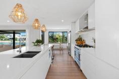  3 Marlin Court PALM BEACH QLD 4221 $1,700,000 This boutique waterfront home has been fully renovated to create a relaxed, modern coastal ambience utilising stylish high end fixtures and fittings with a combination of colours and textures that combine to delight the senses. The design of the home maximises the indoor/outdoor waterfront living environment with the kitchen and open plan living areas flowing seamlessly to the covered outdoor entertaining area and pool through timber bi-fold doors. Features include:- • Facing north to the water with your own sandy beach and direct ocean access; • Gourmet kitchen with 50mm stone tops, 2-pac cabinetry and custom black butt breakfast bar; • Master bedroom suite with timber bi-fold doors opening to capture the water views: • Finishes in the master suite include solid timber joinery and custom vanity, concrete bath and basins; • Main bathroom also with designer bath and basins and blackbutt vanity; • Grey wash oak flooring throughout to enhance the coastal feel; • Fully tiled Inground pool using Indonesian Sukabumi natural tiles; • Spotted gum timber decking to the entry and also alfresco area; • Floating pontoon with rollers for easy boating access; • Air conditioning, 6.6kw solar power; • Electric gate allowing additional secure, off street parking. This recently completed home is in an excellent location offering one of the closest waterfront positions to the beach and associated facilities in the area offering a great lifestyle location where you can literally walk to the beach, cafes and restaurants when you are not at home enjoying your own aquatic playground.. 