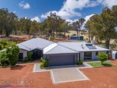  1430 Green Street Wooroloo WA 6558 $799,000 Designed for family, orientated for views and created for multi-generational living, this 4 bedroom, 2 bathroom home with a self-contained 1 bedroom, 1 bathroom unit under the main roof, offers spacious, flexible living in an idyllic valley setting. With White Gum Gully running along the bottom of the 5-acre parkland block, access from both Green Street and Government Road and the adjoining Heritage Trail, this property offers a thoughtfully designed home in an idyllic setting that is sure to be at the heart of family life for generations. • 	 4 bedrooms 2 bathrooms • 	 1 bed, 1 bath unit UMR • 	 2006-built brick and iron • 	 Study, media, activity rms • 	 Central open plan living • 	 Spacious principal suite • 	 Jnr wing w double rooms • 	 Vast alfresco entertaining • 	 Valley views and creek • 	 Dual access 5-acre block • 	 Premium Wooroloo locn Set high in a valley overlooking rolling parkland and distant hills, this 2006-built rendered brick and iron home is a big, beautiful and welcoming.  Multiple living spaces, a splendid central open-plan design, and an extensive outdoor living area fashion a flexible, family-focused home with the added benefit of stylish and spacious auxiliary accommodation. A deep, decked entry leads to double doors and the welcome of 31-course ceilings, light-filled rooms and a modern, neutral colour scheme. The layout of the home sees quiet, private spaces – a large carpeted study, hygge media room, and an expansive principal bedroom suite – arranged away from the activity of the central living zones. The spacious main suite features soft carpets, valley views and bedroom large enough for a peaceful seating area – the perfect parents’ retreat.  The sense of an indulgent hideaway continues thanks to a fully tiled ensuite with separate W.C. and a large walk-in robe. Taking pride of place at the heart of this home is a luminous, open-plan living area where a large, practical kitchen, family room and meals area merge into separate activity and playrooms, and out to the alfresco entertaining zone. The kitchen features a sweep of high benchtop with integrated breakfast bar, ample storage, a walk-in corner pantry and an appliance nook. A 900 mm oven, 5-burner hob and dishwasher will delight the most passionate of home cooks. The style and practicality of the living and adjoining outdoor entertaining areas deliver an impressive backdrop to weeknight meals, family celebrations and legendary parties. A large alcove off the central living zone offers a degree of separation within ear- and eyeshot of the home’s hub – perfect as a playroom for young children, screen-time space for older kids, or a wonderful, cosseting library when you want to curl up with a good book. A large games room with access to the alfresco entertaining zone delivers a transitional indoor-outdoor space. The separate junior wing comprising three large bedrooms arranged around a family bathroom designed for the realities of family. Each of the bedrooms is filled with natural light and fitted with built-in robes. The shared bathroom features a walk-through powder room with a separate W.C. leading into a separate room with shower and bathtub – the morning rush to get everyone out the door on time just got a whole lot easier. Sitting under the home’s main roof is a spacious and stylish apartment with an open plan kitchen/meals/living room, large, bright bedroom and well-appointed ensuite. The kitchen features ample bench and storage space a walk-in corner pantry and an under-bench oven and 4-burner hob. A separate entrance, split air-conditioning, views across the valley and access to the gable-roofed entertaining area deliver the best of both world for grandparents of adult children – independent living with shared spaces. Family life is hectic, no matter the size or stage of your family, this impressive property is up to the challenge. Five acres of parkland, a creek, and incomparable views provide Hills charm, while scheme water, ducted reverse cycle air-conditioning, and easy access to arterial road links make the day-to-day business of family a little easier. Put simply, this all adds up to a rich, memorable and rewarding Hills life. To arrange an inspection of this property or to receive exceptional service delivered with relaxed confidence, call Brad ‘Rundin’ Williams today on 0408 887 375. 