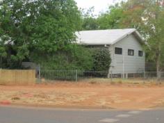  106 Staunton Street Tennant Creek NT 0860 $245,000 This well established corner block boasts a lovely shady garden with verandas front and back to capture the breeze and provide relaxing places in which to enjoy the serenity. 3 steps lead up to the security screened, shade-cloth enclosed front veranda which provides the entry to the large open plan lounge and dining area.This space is kept comfortable by evaporative air-conditioning services this area and is aided by ceiling fans. Reverse clycle aircond in the lounge room The kitchen runs off the dining area and comes complete with a dishwasher, Gas range, good bench space and ample cupboards that will keep the family chef smiling. At the far end of the kitchen is a second area that could be used as second lounge area, office, reading room....the choice is yours. This area also has its own TV data point. The Master Bedroom is MASSIVE with a fabulous walk in robe that any woman would envy, a second storage area which backs onto the bathroom was originally planned to be an en-suite, but family growth has slowed this conversion down. The 2nd & 3rd bedrooms are of generous proportion with BIR's, and and all bedrooms have S/S aircons, and ceiling fans. The laundry, toilet and bathroom all run off the hallway, with the bathroom enjoying a full size bath and separate shower. The toilet is also separate. At the back door is another covered veranda. Steps lead down to the backyard and a small veggie garden has already been established. There is also a good sized garden shed and aviary. This property is fully alarmed with a direct connection to a security company. This property is worthy of your inspection. 