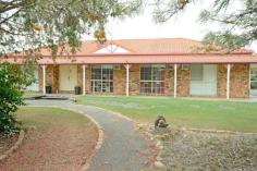  15 Hills Avenue Biloela QLD 4715 $459,000 A low set brick home set on 4007sqms* in an established neighbourhood, on the edge of town. This is just for starters. A large, open plan living and dining with a very stylish and renovated kitchen. Finished in white two-pak, stone benches and equipped with quality appliances. Three good sized bedrooms with ceiling fans, air-conditioning and built-in robes. The master has an impressive ensuite and a walk-in robe. Outside, the 9m* x 6m* undercover entertainment area is the perfect spot to entertain or just kick back and relax. From here you can enjoy the company of family and friends and the in ground, saltwater pool. Just perfect for our long, hot summers. A 3 bay (2 door), powered shed as well as a separate car port allows parking accommodation for up to 5 vehicles. The acre is fully fenced with an underground sprinkler system to keep the lawn green and make good use of the included John Deere, 0 Turn ride-on mower. All of this and still more so inspection is highly recommended. Private inspections are available upon request. FEATURES: • 	 Air Conditioning • 	 Built-In Wardrobes • 	 Garden • 	 Secure Parking.. 