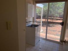  8/11 Pine Crescent Roxby Downs SA 5725 $175,000 This comfortable homette situated at the end of a cul-de-sac has open plan layout with kitchen adjacent to the family area. Ducted air-conditioning throughout, built in robes in the bedrooms. Kitchen featuring double sink, gas stove, oven, rangehood, double alcove, pantry, overhead cupboards and room for a dishwasher and microwave. The bathroom has a large bath/shower, exhaust fan and mirrored cabinet. There is a back verandah, garden shed with power, washing line and gates providing vehicle access to the backyard. 