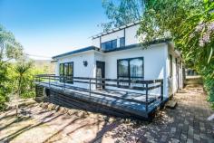  3 Laxton Street Goughs Bay VIC 3723 $380,000-$410,000 On just over 1000 square meters sits this double story villa with amazing lake views just moments from Gough Bays licensed general store and deep water boat ramp. Positioned on a no through road ensures bustling holiday traffic is limited. Outside construction plus deck has just been fully repainted whilst the inside reveals ultimate character with hand crafted wood detailing and retro tiles in the ensuite, shower room and laundry. Step inside from the front deck and you'll be met with an open plan living and dining space which then leads through arch ways to the kitchen, complete with mosaic bench tiling and large glass doors, opening to the deck and back yard making indoor/outdoor living a breeze. Single garage, single carport and side access allows plenty of space for cars and maybe a boat! Down stairs is a split level master bedroom where you can lay and enjoy the view and also pamper yourself in the large en-suite with shower. There is also a further 2 bedrooms and shower room. Option for walk in walk out Secure your new home, investment or holiday home today and call Team Canavan! 