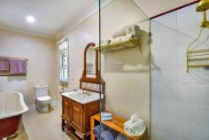  36 Nerrim St Bundanoon NSW 2578 $995,000 This old gem was the original homestead in Nerrim Street with construction started in 1953 and sympathetically restored in the last 12 months. The current owners have retained much of the charm and character of this cottage whilst ensuring modern convenience for an ease of living. All the external fibro has been removed, walls fully insulated and fibro replaced with Heritage profile timber weatherboards. The iron roof has been fully restored and new downpipes and guttering added; Old world charm throughout with high ceilings, timber floor boards, French doors, stained glass, claw foot bath, high skirtings and so much more; Cosy country kitchen with quality appliances offers views over the sun drenched north facing garden and flows to the intimate breakfast room or possible home office with its own entry off the front deck, both a lovely place for your morning coffee or work from home space; Main living area is grand in scale with a gas fireplace the focal point of this generous space which offers formal dining and lounge and accesses the rear deck via French doors; Master suite is also sizeable with excellent double robes and fully renovated period bathroom with claw foot bath; Guest/family wing offers another 3 double light filled rooms with views over the cottage gardens all serviced via the main bathroom which is also fully renovated; Laundry has excellent storage options and accesses the rear yard; Main heating is via a gas fireplace together with reverse cycle split a/c; and Nobo room heaters in all bedrooms and hallway. The house is fully insulated, with insulation under floor in certain rooms as well. Electricity charges are off-set via the 6Kw solar system with 5Kw inverter; Positioned to maximise the northern sunshine, the home offers a bright and airy feel throughout, further enhanced by the 9ft ceilings and large timber windows; Outdoor entertaining is via a long east facing deck overlooking the rear established garden and pond with large open lawn areas for the family to enjoy or the front terrace bathed in northern sunshine under the vine draped pergola. The property is fully fenced with excellent side access for the caravan or trailer with a double garage to the frontage perfect for 2 cars and workshop space. The garden is a lovely mix of colour, old oak trees, shrubs and roses. Situated in a quiet cul-de-sac, this elevated property takes in a green distant local outlook and is only a 15 minute casual stroll to the village of Bundanoon. 