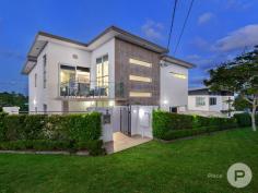 60 Main Avenue Balmoral QLD 4171 Occupying an outstanding location, perched on top of Balmoral hill, this contemporary home offers sweeping views and expansive, executive-style living. Each level of this property is conveniently serviced by an internal hydraulic lift. The top level is an entertainer's delight, featuring a gourmet kitchen, sumptuous lounge and an enormous outdoor terrace, which enjoys spectacular 270-degree views across Brisbane, the Gateway Bridge towards Moreton Bay. The sleek kitchen has granite benchtops, Miele appliances, a large walk-in pantry and beautiful New Guinea rosewood cabinetry. Particular attention was paid to the cabinetry throughout the home and it is extraordinary. There is also a separate bar area and a tranquil sitting room, which accesses another balcony. There are three bedrooms on the mid-level, including an opulent Master suite, which boasts a walk-in robe and a stunning granite ensuite with spa bath and separate shower. There is also a full bathroom for the other bedrooms, plus a powder room. A light filled casual lounge area opens directly onto an outdoor terrace and a fully tiled swimming pool, catering for easy and relaxed summer living or would be a great spot for a home office. The ground floor of the property is fully self-contained, with 2-bedrooms, a full kitchen, bathroom, laundry and lounge with projector and screen. This is a fantastic feature of the property - ideal accommodation for older children, extended family members, guests or live-in help. There is also internal access to the enormous 4-car secure garage and gym space, while cavernous underground storage would make an ideal wine cellar. The home has ducted air-conditioning throughout, motorised blinds, a CBus security system and there is 50,000-litre water tank for the gardens and toilets. The property is in a highly desirable location, a short stroll to the popular Oxford Street lifestyle precinct, where you will find shops, cafes and boutiques, it's close to excellent public and independent schools, parks and city cat terminals. This is a superb residence, which will appeal to buyers seeking stylish, secure and low maintenance living in an exclusive location. 