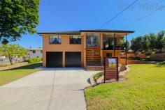  3 Ann Street Bundamba QLD 4304 $549,000 Perfectly positioned right across from Norm Brown Park. This fantastic property will suit the astute home owner or investor. You can live in this beautiful large family home and put simply watch your investment grow. This 2 storey brick veneer home on 3 lots with 2 road frontage, is located in a commanding position in an exclusive suburb, making this property an absolute must see. Bundamba is becoming the place to be, with everything you need close by. You can walk to local shops, rail station, bus stop, swimming pool, primary and secondary schools and even Ipswich TAFE. If you fancy a shop, there are a variety of shopping centres in any direction you can choose from, including Booval Shopping Precinct and Riverlink not to mention the new Costco shopping experience. With Brisbane under 30 minutes* away, this property is one not to miss so come down and check it out. Boasting: • 	 Main bedroom with ceiling high built-in robe and ceiling fan • 	 2 other generously sized bedrooms also with tall built-ins and ceiling fans • 	 Modern kitchen with Caesar Stone island bench with induction cooktop, soft close drawers and quality appliances such as Westinghouse oven plus Miele dishwasher with a 4 star water rating • 	 All taps and toilets also come with a 4 star water rating • 	 Open plan living area that leads out to the balcony overlooking the park • 	 Panasonic air-conditioning in the open plan living area • 	 Spacious bathroom with Caesarstone bench tops, laundry chute and his and her wash basins • 	 2nd living area downstairs currently used as media room and gym leigal height for 4 bedroom • 	 Duel car accommodation with workshop and sealed concrete flooring • 	 Laundry and stylish second bathroom downstairs • 	 Internal stair access to upstairs • 	 Steel stumps throughout for extra stability • 	 1.5kw solar system to keep the bills down • 	 Convenient location opposite park in local traffic only area • 	 Beautiful manicured lawns and gardens • 	 1,410m2 corner block on 3 lots This beautiful home just screams quality and won't last long, to book a private inspection contact Neil Mundy today! FEATURES: • 	 27 • 	 28 • 	 Air Conditioning • 	 Built-In Wardrobes • 	 Close To Schools • 	 Close To Shops • 	 Close To Transport.. 