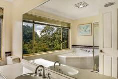  4 Ben Nevis Cct Bundanoon NSW 2578 $1,045,000 This solid brick and tile residence is spread over 3 levels and offers fabulous spaces for the whole family. Set amongst glorious grounds with privacy and perfect northern exposure assured. A blue ribbon location with distant escarpment views in the village of Bundanoon. All four bedrooms are generous in size with excellent storage available, the master suite offering a walk in robe and huge ensuite. The main bathroom is also sizable and is situated on the upper level to service the 3 double bedrooms; There is potential for a fifth bedroom on the ground floor currently used as the home office with access to the guest powder room; Living is spread over the lower level and mid level of the home with both casual and formal living and dining spaces perfect for entertaining and the growing family; The modern kitchen accesses the rear verandah and offers stone bench tops and quality finishes. The formal dining and casual dining space both flow seamlessly to the kitchen space and outdoor BBQ area; There is ducted heating and cooling plus a flued gas heater in the casual family / rumpus area which also accesses its own private terraced area, fully enclosed, perfect for the little ones or family pet; The double garage has internal access into the entry foyer and offers more storage options, with side access to the rear yard also available and plenty of off street parking. Set well back from the street, the park like grounds offer a mix of established trees, garden beds, retaining walls, year round colour and large level grassed areas. A fabulous family home in a quiet leafy location within walking distance to the charming village. Call Megan to arrange your private inspection. 