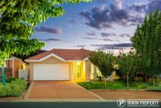  12 Bywaters Street Amaroo ACT 2914 This immaculate and spacious family home, set in an ideal, family friendly location, offers a long list of features making it a must-see property for many home buyers. THE HOME A manicured front lawn and gorgeous Crepe Myrtle trees offer an inviting welcome, hinting that you're inspecting something special. The formal tiled entry leads into a large formal living space comprising of a dining area and lounge area. The space offers flexibility, ability to be closed off from the rest of the house and lovely natural light from the north. The heart of the home consists of the kitchen and an open plan family/meals area that opens onto the pergola area and the rear yard via sliding doors. This is a great space, sure to be the centre of family life. Extra height ceilings run through the living and kitchen areas. The large kitchen offers ample bench space including breakfast bar, generous storage (great pantry) and updated quality appliances, including a 5-burner gas cooktop plus a Westinghouse oven and dishwasher. The master bedroom is a spacious size and features a large walk-through wardrobe with some clever storage ideas and a nicely set out ensuite bathroom. There are three additional bedrooms, all well sized and featuring built-in wardrobes. The main bathroom features a corner spa bath and a separate toilet. The level, rear garden features an alfresco/pergola area, low maintenance gardens, brand new turf and a handy garden shed. Additional features include ducted gas heating and evaporative cooling, split system air-conditioner to the family room, Rinnai continuous flow gas hot water, plus energy efficient curtains and pelmets. The double garage benefits from internal access, a power door opener and a generously sized driveway allowing for plenty of off-street parking. There's also drive through access to the rear yard giving the option to use the garage as an additional outdoor entrainment area. THE LOCATION Positioned on a quiet street opposite green reserve, the block offers an ideal northern orientation. Within a walkable 1.2km is Yerrabi Pond, a lovely spot for an evening stroll, enjoying the surrounding parks and feeding the ducks. The Yerrabi waterfront also features a number of businesses including restaurants and a hair salon. Within just 1.5km, there's Amaroo School, Good Shepherd Catholic Primary School and the very popular Amaroo shops featuring a Coles & Aldi supermarket. Only 2.4km away, the Gungahlin CBD offers a vast array of shopping outlets, schools, gyms, medical facilities, restaurants, cafés and a light rail station.. 