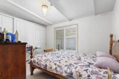  17 Fraser St Clunes VIC 3370 $350,000 Nestled behind the gorgeous leafy canopy you will find this quaint 1 bedroom cottage in the heart of Clunes heritage precinct of town. 450metres to the cafes, currently tenanted it is the ideal investment opportunity to add to your portfolio. Updated open plan kitchen/dining/lounge with bamboo flooring, the modern kitchen boasts a 900mm upright stove, gas cooktop/electric oven. The large bedroom has carpet floor covering, and ample storage with a wall to wall built in robe. Off the kitchen is a step down, room which would make the ideal home office or extra utilised as a guest room. The centrally located bathroom features pressed metal splashback behind vanity, good sized corner shower, toilet, and plenty of space to move about. Plantation shutters throughout the home make for a charming addition to the property along with the feature chandeliers throughout. Outside, the established cottage garden provides both privacy and summer shade, sit in the garden and watch the world go by, or utilise the deck for entertaining friends and family. Car access from Purcell St to the garage and caravan pad. Features include: • 1 Bedroom • Study/guest area • Open plan living/dining/kitchen • 900mm gas/electric stove • Dishwasher • NBN • Town water • Town Sewer • Rainwater tank • Split system • LPG instant hot water • Double lock up garage • Extra park/caravan pad • Tenanted at $220 p/w Clunes is a historic Central Victorian township, and popular destination within 2hrs of Melbourne. Less than 30 minutes to Ballarat and Maryborough and an easy 40-minute drive to Daylesford. Rich in diversity and community spirit, you do not just buy property in Clunes, you are welcomed into the community family. Inspection by appointment only as property is tenanted. Please phone Angela Flowers on 0437 456 908.. 