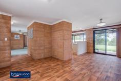  42 Blackboy Way Morangup WA 6083 $499,000 Embrace a life close to mother nature in this rammed earth, homestead-style property set on 5-acres. Organic textures and tones ensure the home sits lightly within its natural landscape and bring a delightful calm to the interior spaces. A central open plan leading to separate adult and junior wings forms a practical floorplan. Wide verandahs, a below ground pool, and a 6 m x 9 m shed offer ample inducement to outdoor living and a delightful sense that all you need is right here. • 	 4 beds, 2 baths + study • 	 1994-built rammed earth • 	 Central open plan design • 	 Separate bedroom wings • 	 Wide paved verandahs • 	 6m x 9 m Colorbond shed • 	 Below ground swim pool • 	 Pool house/games room • 	 5-acres productive bore • 	 Space, seclusion, nature Warm, earth tones and the organic texture of rammed earth construction create a home that blends effortlessly with its surroundings. Set towards the centre of the 5-acre lot, a sense of privacy and space descends as soon as you enter the property. A double front door entryway is flanked by an open plan kitchen/meals/family room and a spacious, carpeted lounge. With easy-care, timber-look floors, a slow combustion fireplace (with a wetback to heat water during winter), a gas bayonet, and reverse cycle air-conditioning, the flexible open plan area is sure to be at the heart of family life. A subdued atmosphere fills the carpeted lounge, a spacious and inviting space to enjoy at-home movie and games nights. This formal space creates a transition between the open plan area and the privacy of the principal suite. The main bedroom is a generous size with a walk-through wardrobe leading into an ensuite with shower, vanity and W.C. Earthen walls and soft carpets fashion a calm retreat away from the activity of the central living zone. This separation from the home’s busy, shared spaces makes the adjoining home office ideal for uninterrupted work or study. A separate junior wing, comprising three good sized rooms – two with built-in robes – a shared bathroom with bathtub, vanity and shower, and a walk-through laundry with a separate W.C. completes the interior floorplan. Paved verandahs at the front and rear of the home offer a choice of outdoor living areas with garden views to the front and poolside convenience to the rear. The below-ground salt pool is surrounded by a small lawn and offers views of the tree canopy while floating. A pool house/games room expands the outdoor living space. At the property’s southern boundary, a 6 m x 9 m Colorbond shed with a concrete pad and potbelly stove is waiting to be transformed into an enviable man cave. Those who yearn to live close to nature will discover the peace and tranquillity of life surrounded by open space and a home that blends beautifully with its setting. The power of this rural paradise is so beguiling that you may never want to leave. However, access to a school bus route and Toodyay Road mean the rest of the world is there when you want it. To arrange an inspection of this property, call Cheryl New on 0439 961 192. 