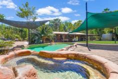  500 Strangways Road Humpty Doo NT 0836 This stunning tropical property presents luxury rural living at its best with spacious light-filled interiors opening to a wrap-around verandah and expansive entertainer's patio with in-ground pool and spa, all set on five fully irrigated acres moments to a major shopping centre, 10 minutes to Palmerston and an easy 30-minute commute to the city. • 	 Lush tropical gardens extend throughout this beautiful five-acre property • 	 Open-plan main living area with sunken lounge plus dining area • 	 Soaring pitched ceilings with exposed beams create sense of light and space • 	 French doors open to huge entertainer's verandah and paved patio • 	 Resort-style in-ground pool and spa set amidst private tropical gardens • 	 Quality modern kitchen with stone bench tops and walk-in pantry • 	 Main bathroom with large glass shower, new toilet and timber vanity • 	 Three good-sized bedrooms in main house, all with built-in robes • 	 Separate self-contained granny flat with kitchenette and bathroom • 	 Large workshop doubles as four-car garage; solar power throughout Enjoy all the wide-open space of rural living with all the big-city conveniences just a short drive away from this beautiful five-acre property with immaculate modern homestead. The open-plan main living area boasts a sunken lounge and separate dining area under soaring pitched ceilings that create a luxurious sense of light and space. The living and dining areas both open onto the wrap-around verandah through French doors, and the huge adjoining patio with gazebo and barbeque area is ideal for entertaining - as is the resort-style in-ground pool and spa with waterfall that's set amidst beautiful tropical gardens. The quality modern kitchen will delight the home chef with stone bench tops, glass splashback, stainless steel appliances including dishwasher, breakfast bar and large walk-in pantry. A hallway off the kitchen connects to the three generous bedrooms - all with built-in robes - and modern main bathroom with glass shower and new toilet. A separate self-contained granny flat with kitchenette and bathroom is ideal for the older teen, in-laws or independent houseguest. There is split-system air conditioning and stunning slate flooring throughout, and the huge workshop doubles as a four-car garage. 