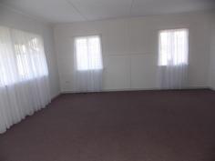  25 Margaret St Yarraman QLD 4614 $245,000 In these changing times, where people from the south move to Queensland and big city dwellers recognize the value of the big open spaces, here is a wonderful opportunity to live in a rural township where the Toowoomba council is improving the surrounds and residents are banding together to make it a great living. Everything is in walking distance, school, bank, doctors, bakery, cafes, butcher, produce place, IGA. The house has a friendly, open and light energy. The bathroom is large with shower and bath tub and instant gas hot water. The front veranda extends from one end of the house to the other, opening into a large square at the front entrance. At the back is a ramp for ease of access to the house. 2 beautiful poinciana trees at the front act as a barrier between the road and house and are an amazing view to wake up in the morning.The bedroom has french doors that open onto the veranda. Also trees are planted along the fence line for privacy and as wind break. A large water tank ensures plenty of drinking water. A double carport is at the back and a greenhouse for use as you please. 