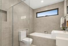  2/72 Nimmo St Essendon VIC 3040 Nestle into this prestigious neighbourhood and enjoy the generous space this architecturally designed town home offers. Finished to the highest of standards and showcasing luxury inclusions, this flawless home is ready for you to enjoy. Lavish Blackbutt solid timber floors seamlessly guide you from the entry, through the large living space and into the open plan kitchen/dining that’s bathed in natural light. Hosting is seamless in the contemporary kitchen that’s wrapped in 2-tone cabinetry, stone benchtops, and an entertainer’s island bench. Amongst substantial storage and extensive prep space, SMEG stainless steel appliances have been fitted. High ceilings are enjoyed throughout the home adding to the already large spaces which flow brilliantly to the outdoor entertaining yard. This luxurious 3-bedroom home continues to provide loads of space on the upper level. The master enjoys its own walk-in robe and luxe ensuite. The 2nd and 3rd bedroom are serviced by a central bathroom that includes a tub. Both bathrooms include porcelain floor to ceiling tiles, stone tops, shaving cabinets and frameless shower screens. A flawless home in a first-class location that surrounds you with convenient public transport options, easy access to Citylink, parks, popular cafes, shops, and restaurants. Conveniently connected to popular private and public schools, it’s the only place to be. Other features include- -Zoned Brivis ducted heating with refrigerated cooling -Guest powder room (3rd toilet) on the living level -2340mm high doors throughout -Stone benchtops to all wet areas -Fridge water point -Square set cornice -NBN ready -Bosch alarm system -Stacker doors -Remote garage -On site guest parking 