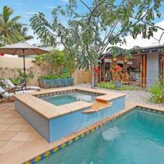  3 Trivia Street, Palm Cove, QLD 4879 HOUSE FOR SALE IN PALM COVE STUNNING BEACHSIDE PAVILION RESIDENCE AT AN EXCLUSIVE ADDRESS 4  Beds  2  Baths  2  Cars An immaculately presented home in the heart of the Golden Triangle of Palm Cove where the Mediterranean meets Tropical North Queensland. The blending of architecture with bespoke design features and stylish decor makes this elegant residence a cut above the rest. Located opposite Tom McDonald Park, and just a three-minute stroll to Cairns' premier beach, this home is in the best street, in the best suburb, north of Brisbane. Designed and built by Chris Blanche, this breathtaking private residence comprises two pavilions where its engagement with the tropical surrounds welcomes the outdoors in, all year round. The impressive entrance entices you across an enchanting timber bridge over twin fishponds surrounded by exotic tropical plants, setting the tone and welcoming you into an open courtyard between the two pavilions. The front pavilion houses the open kitchen, lounge, dining, and covered alfresco entertaining areas, all of which overlook the pool, the spa and the lush tropical verge surrounding the property. The rear two level pavilion features three ground floor bedrooms, bathroom, laundry, guest toilet and ample storage; while the parent's retreat master bedroom is on the upper level complete with WIR and ensuite. This level has wrap around windows offering a picturesque view across to leafy expanse of Tom McDonald Park, a view which is framed by the large Pandanus palms directly below. This beautiful home lends itself to entertaining in style as the front pavilion houses natural timber concertina and French doors that open onto the covered patio and terracotta tiled pool area, opening the entire living area up and inviting the outdoor ambience in. With a recent kitchen makeover, the installation of solar heating. LED lighting, eco ceiling fans and window tinting, this home is perfect for families and friends to enjoy being part of the Palm Cove luxe resort lifestyle. There is so much to love: A fully fenced 700 m2 block with professionally designed gardens, complete with fully functioning water reticulation system Bespoke wrought iron gates and ironwork by Elefantus Double remote garage with lots of storage Solar panels installed Heat resistant protective paint applied to roof High ceilings throughout and wide walkways Fully air conditioned Kitchen with breakfast bar, gas cooking, and granite bench tops Extensive custom-made timber windows, louvres and doors Security and insect screens Just a short stroll from your new home is the beautiful palm fringed esplanade of Palm Cove where you will find an array of fine dining restaurants, casual cafes and boutique shopping. Ray White Smithfield For your private inspection, contact: Matthew Pearce 0418 708 758 Simon Batt 0400 932 229 Land: 	 700m² / 0.17 acres Parking: 	 2 garage spaces Bedrooms: 	 4 Bathrooms: 	 2 