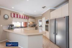  3 Minora Way Jane Brook WA 6056 $515,000 Embrace life in Jane Brook, confident in the knowledge that this home will adapt to the changing needs of a growing family. Multiple living areas, a separate adults’ zone, generous junior bedrooms, and a large media/activity room create a flexible floorplan with a spacious open plan kitchen/meals/family room at its heart. 4 bedrooms 2 bathrooms 2005-built brick and tile Formal & informal living Sep media/activity room Central open plan design Reverse cycle ducted AC Wrap-around alfresco ent 16-panel 3kW solar array Low maint 576 sqm block Parks, lakes, Hills, Valley This spacious family home sits behind the sweep of a green lawn and steps from the open space of Jane Brook Reserve. The front door opens into a tiled entryway with a formal lounge to one side and the spacious main suite to the other. The sunken lounge offers a quiet, east-facing sanctuary away from the activity of the central open plan. In the principal suite, a large bay window delivers ample natural light to a room finished in a calming neutral colour scheme. A walk-in robe and well-appointed ensuite build on the atmosphere of a private retreat. At the heart of the home is an expanse of open plan living with an adjoining activity media room. This flexible design delivers the freedom to adjust to changing priorities as your family grows and needs change. The kitchen is set in one corner of the open plan area and features a 4-burner gas hob, an electric wall oven and a walk-in pantry. A shoppers’ entry, ample under bench storage and an integrated breakfast bar make daily life a little easier. With space for a family-sized sofa and table and access to the wrap-around verandah, this family hub is sure to provide the backdrop to years of memories. Double doors open to reveal a large media/activity room and expand the functional living space. A gas bayonet in this room supplements ducted reverse cycle AC throughout the home. In the separate junior wing, three good-sized bedrooms with carpet and built-in robes are sure to delight children of all ages. A shared family bathroom with tub, shower and vanity, a separate WC and a walk-through laundry complete the layout of the junior wing. A sliding glass door connects the central living zone to a paved wrap around verandah with the 2-car garage at one end, and a Colorbond garden shed at the other. This expansive area, edged with raised garden beds, offers year-round outdoor living with both northerly and westerly aspects. Steps from the front door of this home is a reserve and walking path leading to the lakes and parks of Jane Brook. The shops and services of Midland are a short drive away, and primary and secondary schools are within easy reach. A Foothills setting delivers the outdoor adventure of the Perth Hills and the gourmet delights of the Swan Valley in equal measure. 