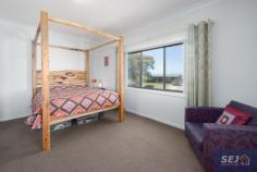  87 Victoria St Toora VIC 3962 $560,000 Enjoying a quiet location at the end of a no through road, elevated to look out over the surrounding farmland to the waters of Corner Inlet and mountains of Wilsons Prom, this immaculately presented residence is a delight to inspect. Set on approx. 611m2 corner block with a double LU garage with front and side access, plus parking, and a separate studio or home office. Enclosed front sunroom with Prom views. Comfortable living room with magnificent solid timber flooring and the convenience of a RC/AC. Stunning kitchen with gleaming cabinetry, 900mm dual fuel stove, stone look bench tops and breakfast bar. Sundrenched rear family / dining room with northerly aspect and views to distant hills. 3 fitted bedrooms, 2 ultra modern bathrooms, one with laundry facilities. Everything has been thought of - 5kW solar power system, fully fenced secure rear garden with paved entertaining patio, raised veggie beds, low cost instant gas hot water. NBN high speed internet. Will appeal to a fastidious buyer - just a minutes walk to the Rail Trail, 2km from boat launching and a stroll to the center of town. 