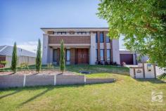  21 Thorneycroft Avenue Wodonga VIC 3690 $725,000 to $750,000 With a commanding and stately presence, this 2011 built home is sure to grab your attention. Situated on a spacious 855m2 block, offering four bedrooms, two and a half bathrooms and four living areas, this impressive home has been elegantly designed to accommodate the needs of an expanding family. As you enter the home through the double wooden doors, the impressive foyer greets you with an elegant staircase and stunning polished tiles. You will find the formal lounge room to your left and the home office or study to your right, both bathed in natural light, overlooking the quiet street front. The grand staircase leads to a central living space upstairs, with all four bedrooms and the main family bathroom adjoining. Space is luxury, and this master suite will not disappoint. With double glass doors opening onto the private balcony, a huge walk-through robe and a generous, luxury ensuite, this master is the pinnacle of comfort. This kitchen is a chef's dream, with ample storage options, a huge walk-in pantry, stainless steel appliances, including a 900mm wide oven, and stunning stone benchtops. The spacious open plan kitchen, living, dining flow out through glass doors to the undercover alfresco area. With space for all the family, the generous rumpus room is versatile and would make the perfect kids play area or home theatre. The backyard is very low maintenance with plenty of scope for a future pool or shed (STCA). The double lock-up garage can be accessed via the internal door through the laundry or backyard through the single rear door. With 321m2 of living space, what more could you ask for? 