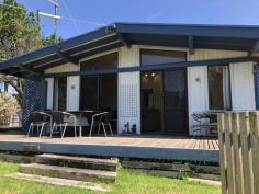  12 Banksia Ave Sandy Point VIC 3959 Secluded on a fully fenced approx. 600m2 block with an open northerly aspect and great beachy feel, this is sure to appeal. Offering a private sanctuary in a quiet location only 3 minutes walk to Ned Neales lookout and the dog friendly beach area. Open plan living / dining area is comfortable year-round with a wood heater and the convenience of a RC/AC, opening out to a large entertaining deck - just the spot for a BBQ on a warm summer evening. Well appointed kitchen with abundant bench and storage space plus a servery to the meals area. 2 bedrooms - master with wall of robes, central modern bathroom with separate w.c., laundry / utility room with built in storage. Second sitting room with skylight and RC/AC - ideal for working from home or convert into a 3rd bedroom. LU garden shed, carport. Light and bright with neutral tones throughout creates a no-fuss interior complimented by an easy-care block with flat lawn area plus a screening of trees for shade and shelter. Bore and tank water. Being sold fully furnished and ready to enjoy in this sought after coastal location. 
