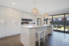  13 Hampshire Boulevard Leneva VIC 3691 Why build when you can purchase this brand new, supremely finished home. Master-built by Sapphire Sky, in the growing estate of Kinchington. Set amongst other quality homes, in an elevated position taking in the beautiful rural outlook of the surrounding picturesque Wodonga hillsides. Light and bright throughout, this is an immaculately presented family home. Offering four generous bedrooms all with mirrored built-in robes. The large master bedroom features a walk-in robe and ensuite complete with double shower. Views of the hills are captured from the front bedroom and lounge room. Living space for the family is very comfortable with a front formal lounge and rear family room with adjoining dining and a modern kitchen. The galley style kitchen features great storage under the bench and overhead, stone benchtops, soft close draws, dishwasher, 900mm electric cooktop, and oven. The glass window splash-back together with a light color palette makes this kitchen modern and fresh. A full family bathroom and laundry with great storage options and modern fixtures and fittings complete the internal layout of the home. The provision of walk-in storage off the entryway provides a practical multi-purpose place for coats, school bags, etc. A double lock-up garage with remote and internal access provides car accommodation, additional access to the backyard is via a dually hinged side gate with room to store your caravan/boat/trailer. Covered outdoor entertaining, located off the family room, offers terrific space for year-round enjoyment. A fully automated irrigation system makes for easy yard maintenance. Other notable features include zoned ducted heating and evaporative cooling. Set on a great sized 475m2 allotment with 19 squares of living and built this year, this fantastic home will provide you with comfortable family living. Offering all the bells and whistles with minimal upkeep, start enjoying your carefree lifestyle living! Call us today! 