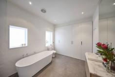  108 Eskdale Rd Caulfield North VIC 3161 $1,550,000 - $1,650,000 Superbly renovated, spacious open plan living with impressive indoor/outdoor connection and surprising tranquillity. This brilliant property contains 3 generous double bedrooms, all with impressive integrated storage, 2 newly updated bathrooms, and an excitingly large open plan kitchen/living/dining space surrounded by lush gardens. This Art Deco classic with a modern extension will impress with its space and privacy. No detail has been overlooked, from the lovingly restored original ornate ceilings, gorgeous hallway with custom bookcase and the marble mantle open fireplace, through to the full height picture window that impresses guests on arrival. In the modern, light filled and expansive family bathroom you'll find a gorgeous freestanding bath, marble vanity, substantial storage, and European laundry. The amazing chef's kitchen with stainless steel bench-top, extensive storage, concealed fridge/freezer and pantry spaces, Ilve 900mm stove, Qasair extractor range, integrated Miele dishwasher, a Carrara marble topped movable island bench will excite the senses, and the chef in the family. Double glazed doors open into the north facing outdoor oasis that includes a readily accessible and plentiful kitchen garden, while the light filled living space adjoining is also easily openable to the lush surrounding gardens and wrap around deck. The highest quality finishes have been used throughout, Carrara marble, designer lighting and double-glazed commercial grade glass, and a year-round climate control via zoned, refrigerated, ducted cooling and heating give this exceptional home an unmistakable edge. Outside garden lighting, extensive sprinkler system, dual water tanks and an automatic gate leading to secure parking for two cars including an open garage with concealed shed and workshop spaces ensure a complete hassle-free and hands off lifestyle. This highly convenient locale gives quick access to Caulfield station, tram, and bus services, is a short walk to Caulfield Park, and within an easy distance of the various private schools in Caulfield and surrounding suburbs. 