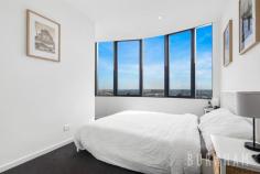  2206/8 Hallenstein St Footscray VIC 3011 $575,000 - $625,000 Enjoy awe-inspiring, unobstructed, sweeping views of the Maribyrnong River and Flemington Racecourse in this new, luxe and spacious two-bedroom apartment. Perfect for first homebuyers and investors alike. Upon entry, timber floors guide you to the open plan living and dining area. This space features curved panoramic windows that allow light to fill the room and frame the views of the surrounding landscape. Indoor/outdoor entertaining is made easy as this area opens to the entertainer’s balcony where the outlook is truly breathtaking. The homes kitchen fuses style and functionality. It boasts extended stone bench tops, Bosch stainless steel appliances, integrated fridge, hexagon splashback tiles, black hardware and an abundance of storage. The master suite is large and light filled featuring curved, wall to wall windows. It is serviced by an ensuite with a large shower. The second bedroom follows similar trends with racecourse and river views. Both bedrooms feature luxe charcoal carpeting and substantial, mirrored built-in robes. The central bathroom features shaving cabinets, floor to ceiling tiles, hexagon feature tiles, black tapware and a large shower with rainfall shower head. The apartment is completed by a European laundry and separate linen cupboard. Enjoy all the amenities Vic Square has to offer, including, the sky garden on level 4, a fully equipped gym, pool, games room with billiards table and cinema. If that isn’t enough, located only 6kms from the city, take advantage of its close proximity to everything your heart desires. Footscray’s burgeoning bar and restaurant scene, Victoria University, Footscray Train Station, the Maribyrnong River, bus and tram tops and Footscray Park are a short walk away. Additional features: – Split system air conditioning and heating in the lounge – Window furnishings – Secure intercom entry – Designated spot in secure, underground car park. 