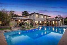  46 Maitland Street Davidson NSW 2085  $2.9 million This stunning contemporary home features an amazing pool and entertaining area, flush with a huge entertaining gazebo with BBQ, all overlooking the resort style pool. Come home from work to relax or entertain. Constructed of brick and tile this home has been completely remodelled, it presents freshly painted, with new kitchen and bathrooms, new floors and landscaping. Set on the high side of the street with amazing views over bushland to Gordon and St Ives, the home is breathtakingly private with no one overlooking you, and hidden behind large brick fences. Entrance is alongside the garage through a security gate with Intercom and camera, this leads to a large, covered walkway between the house and the pool area. The home features two totally distinct living areas that both flow through French doors to the covered deck and pool. The casual living area leads off the garage and has a bathroom & toilet that services the pool and lower level of the home, the other living area flows from the kitchen and also features the dining room, it also flows through opposing French doors to the rear yard and pond. It features timber floors, raked ceilings, split system aircon & is full of light. The modern kitchen features granite benchtops with waterfall edges & stainless appliances, dishwasher and a double bowl sink overlooking the garden through the huge picture window. Upstairs you have 4 bedrooms, plus 3 bathrooms, all with built-ins or walk in wardrobes, plus timber louvers on windows, ducted aircon throughout the upper level, three of these are King or Queen sized. The main bedroom features a master retreat alongside the King size bedroom, this leads to a huge new ensuite with full length tiling and double bowl vanity. The main bathroom is new with full bath and shower modern vanity & full-length tiling. The easy-care gardens feature a decorative fish-pond in yard plus entertaining area overlooking elevated bush views to Killara and St Ives. The huge resort style pool feature underwater lights, plus solar heating to lengthen the swimming season, and huge Cabana with BBQ to get away from the sun. Garaging has parking for 2 + cars in the double lockup garage with internal entry & electric door, plus plenty of storage or workshop room, plus parking on the driveway for a further 4 cars. Other features include timber floors throughout, freshly painted throughout, downlights throughout, close to local schools and transport, overwhelmingly quiet & private. 