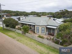  16 Sunshine Rise Sandy Point VIC 3959 $895,000 ust a minute's walk to the main beach access and the café, there is much to like about this surprising property. Big enough for the largest of families to live in full time, to accommodate holiday guests as a BNB, or just to spread out and relax. Light filled 'L' shaped living / dining room with the comfort of wood heating plus the convenience of RC/AC. Central modern kitchen with island / breakfast bar and exceptional storage and preparation areas. Study plus 4 bedrooms - three with ensuite bathroom access. Central laundry / utility room. Sheltered covered entertaining deck with games or sitting room. Brilliantly maintained throughout with a warm welcoming ambience. So many extra features and minimal running costs with solar and mains power, solar hot water, bore and tank water, NBN. Set on a fully fenced corner block of approx. 601m2 with raised vegetable beds and a LU garage with mezzanine storage. If you are looking for a home, not just a holiday home, this is a must see. 