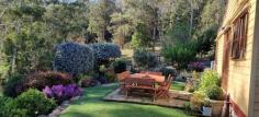  586 Central Rd Mirboo VIC 3871 $895,000 Surrounded by nature on approx. 8 acres of land, in a private setting showcasing gently undulating gardens and bush leading down to a magnificent dam complete with 'Hobbit House', jetty and resident platypus, this superbly presented farmlet is a dream come true. Every aspect has been created with an artist's eye for detail, from the stunning setting planted with feature European and native trees, to the lily filled pond, character shedding and charming Miner's cottage. Productive and low maintenance flower and vegetable gardens frame the entry, leading to an outdoor entertaining area and extensive orchard. Inside the home is a delight - filled with natural light and featuring a gleaming polished timber floor in the open plan living room, warmed by the central wood heater and with French doors to capture cooling breezes. Bespoke kitchen with dining area. Two bedrooms - master with ceiling fan and wall of storage. Character family bathroom with claw foot bath, separate shower and laundry facilities. Up the stairs to a delightful loft bedroom / sitting room with dormer windows providing views over the surrounds. Multiple charming sheds including potting shed, reading room, office, studio, wood shed, storage shed providing ample space to potter around and fill your days. Fenced area of bush with creek and visiting koalas, wallabies and abundant bird life. Sit back, listen to the wind in the trees and the birdsong in this truly unique location. 