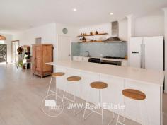  7 Wentworth Loop Dunsborough WA 6281 $795,000 This light filled, stylish family friendly home has been carefully designed and placed on a large 596sqm lot to take advantage of the warmth of the winter sun throughout the living, dining and alfresco rooms and areas. Featuring high 31 course ceilings in these rooms, the spacious well-appointed kitchen features 900mm appliances, stone benchtops, a dishwasher and a massive island bench which has many cupboards and drawers and also doubles as a breakfast bar. The main bedroom is more than generous in size, has a walk-in robe and a large en-suite with a stone top vanity, shower and separate WC. The three minor bedrooms are all oversized, include built-in robes and provide ample room for any size bed with space for other furnishings such as a chest of drawers, desk etc. An activity-come-study area is located between these bedrooms which are serviced by a bathroom with shower, a large bath and vanity and a separate WC. All 4 bedrooms have ceiling fans. At the front of the home is a private home theatre / second living area. The double garage has direct access into the 2 metre wide hallway and gives you plenty of room for cars or extra storage space. This is a sought after location and the property is amongst homes of quality and within an easy walk to the white sands and turquoise waters of Quindalup Beach and Geographe Bay. 