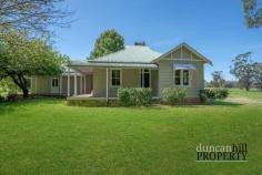  1926 Jamberoo Mountain Rd Robertson NSW 2577 History comes alive in this traditional gem, buoyed with the unmistakable hallmarks of its c1920s heritage and abundant in possibility and heart-warming appeal. Stepping inside, traditional features abound, with soaring ceilings, original floorboards, wall panelling and leadlight detailing combining to evoke a sense of the grandeur the home once represented, and the grace that still exists within it. Placed on a sprawling 5-acre land parcel, there is much to love about this home, and its generous proportions will be the ideal foundation for considered updates that will restore this beauty back to its former glory. High ceilings ⎢Original timber floors ⎢Wall panelling ⎢Leadlight detailing Two wood fireplaces ⎢Slow combustion stove ⎢Reverse cycle a/c ⎢Ceiling fan Sitting room/library with built-in shelving ⎢Lounge room ⎢Dining room ⎢Family living room Huge country kitchen ⎢Walk-in pantry ⎢Ilve gas cooker ⎢Farmhouse sink ⎢Dishwasher Five bedrooms ⎢Walk-in robe and shower ensuite in master ⎢Built-in triple bunk beds Clawfoot bathtub with shower rose and rail and timber vanity in main bathroom Wraparound bullnose verandah Double garage ⎢Huge machinery shed ⎢Woodshed Concrete water tank ⎢Two smaller water tanks Solar panels ⎢Bottled gas ⎢Alarm | Dam ⎢Yurt 
