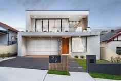  22 Smiths Avenue Hurstville NSW 2220 Placed in an elevated position on a peaceful, wide street this opulent residence is exceptional in its size and appointments, setting a new benchmark for homes in Hurstville. Enjoying a premier northerly rear aspect, it has been exquisitely crafted with not a single detail overlooked and the owner's vision clearly demonstrated through every element. From the moment you first see this home, you are sure to be captivated by the sheer scale of its interiors and long list of high-end fittings and you'll want to call it your own. - Grand entrance with custom front door reveals a dual level floor plan bathed in natural light - Light filled formal lounge starring a double void ceiling, designer pendant light and expansive windows - Open plan living/dining area with gas fire place, bespoke joinery, recessed lighting and curtains - Designer Range quartz kitchen featuring stunning curved island, walk-in pantry and window splashback - Stainless steel Bosch appliances including gas glass cooktop, dual ovens and dishwasher - Five plush bedrooms, all with built-in wardrobes, four on the upper level, three with ensuites - Grand hotel style master suite flows outdoors to sweeping balcony, the perfect parent's retreat - All four chic bathrooms include frameless showers, feature tiles and in-wall toilets, two have freestanding tubs - Home office/study with built-in desk and cabinetry; large laundry with stone benchtop - Generous covered entertaining area with outdoor kitchen overlooks level lawn and sparkling in-ground pool - Separate fully equipped pool cabana, ideal for alfresco entertaining - Double garage with automatic statement door and internal access plus ample space for storage - Ducted air-conditioning throughout, Billie instant hot cold water, security cameras and alarm - Within minutes of quality schools, shops, cafes, restaurants, recreational and transport facilities. 