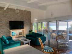  Wooli Holiday Accommodation- Admiral's Deck By  Blue
River Apartments Book your luxury 2 bedroom  apartment offering views across Wooli River to Yuraygir National Park. Admiral's Deck is the premium apartment within the Blue River Apartment block. This premium apartment has an entertainer's kitchen, alfresco dining area and for winter a ethanol fireplace.   