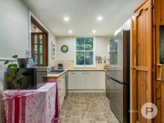  36 Willis St Tarragindi QLD 4121 A celebration of old-world elegance, this dual-level worker’s cottage with tasteful updates is set amongst verdant greenspace. Translating to ‘beautiful’ in the indigenous Yorta Yorta language, the aptly-named ‘Kalimna’ invites you to enjoy a truly fantastic lifestyle. Benefitting from having just one neighbour, the home was originally moved from Kangaroo Point to be positioned in a family-friendly enclave. The property includes: - Grand character façade complemented by ornate fretwork, a covered front verandah and picket-fenced front gardens - Traditional pine floors upstairs and engineered bamboo floors downstairs, as well as lofty ceilings, VJ walls, casement windows and ceiling roses throughout - Generous living area and an adjoining study nook upstairs - Connecting dining room, plus a tidy kitchen displaying a tiled splashback and ample cupboard storage - Large covered rear deck looking out to a lush canopy - Second living area or rumpus room downstairs; the ground level was renovated by Sovereign Homes - Covered rear terrace leading to a fully-fenced artificially-turfed rear yard showcasing mature gardens - Two sizeable bedrooms upstairs and a well-appointed full bathroom - Another two bedrooms downstairs fitted with built-in robes - Second full bathroom and a separate laundry boasting rear terrace access - Off-street parking for one car - Air-conditioning, ceiling fans, a solar power system, security screens and superb storage Only six kilometres from Brisbane’s CBD, this exceptional residence is close to a multitude of shops and dining options. Stones Corner’s attractions, the South East Busway and Greenslopes Private Hospital are also nearby. Falling within the Junction Park State School and Yeronga State High School catchment area, this brilliant home is also a short drive from Saint James Catholic Primary School, Our Lady of Mount Carmel Primary School and Loreto College. 