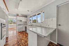 8 Castlereagh Crescent Macquarie ACT 2614 $1,189,000 With five bedrooms and three bathrooms, this spacious property has the clear potential to be a grand family home in a popular leafy suburb on the edge of the Belconnen Town Centre. Step inside and you'll instantly know this home is exciting. You'll be greeted by an internal green space, with the ground floor containing two generous bedrooms, one with an ensuite bathroom - making it a perfect separate living quarter for tenants or relatives. A hidden opportunity on the lower level is to be found behind that mysterious wooden door… where you'll discover the untapped potential of an enormous under-house space, perfect for lots of storage as is, or easily converted to a basement if you desire. Proceeding up the carpeted stairs, you'll find the property's beating heart. Families will love the layout of the three well-sized further bedrooms (all with built in robes), and the two bathrooms. Themed wood paneling and features add a classic retro aesthetic to this level of the home. The kitchen has everything you'll need, including a gas cooktop. The large kitchen window, with heightened outlook, floods light into the room. And the bench space provides all the room you'll need to knead dough, prepare hor d'oeuvres, make your own sausages ... whatever it is, you'll have fun with your friends and family doing it. The kitchen's classic parquetry carries into one of the two large upstairs living areas. The family/dining room and the lounge room both open onto the enormous tiled verandah which enjoys views across the Belconnen treetops. Cleverly positioned on the block to face north, this home takes full advantage of Canberra's stunning natural light. The large backyard is a blank canvas, just waiting on your bright ideas. For example, if you're a foodie, you might perhaps see the potential for a large kitchen garden with veggies, fruit trees and a chook run (if you're so inclined). Macquarie is, of course, a sought-after suburb. With grand trees and wide streets, your home in Macquarie will give you a very pleasant and enduring residential experience. Beyond that, you'll find great benefit in your easy access to both the Belconnen Town Centre (and other many local attractions and facilities) - and to the city! Walkable to the highly regarded Macquarie Primary School and Canberra High School, Macquarie shops and Jamison Centre, the popular reinvigorated Belconnen Fresh Food Markets, Big Splash water park and Westfield shopping mall, you'll have everything you need close by your home. Any nature lovers will appreciate The Pinnacle Nature Reserve just a few minutes walk away. There's a lot to love about this very spacious home - as is, or as you may choose to enhance it. • Expansive double brick home with north facing views towards Belconnen town centre • Freshly carpeted throughout • Seemless flow from both lounge room and family/dining room onto a large terrace via glass sliding doors • Spacious kitchen with gas cooktop, electric oven, Bosch dishwasher and space for a large fridge • Main bathroom with full bath and shower • Upstairs: Three spacious bedrooms all with built in robes and master with ensuite • Downstairs: 4th bedroom/study with ensuite and 5th bedroom/rumpus - both with separate access • Spacious separate laundry • Ducted gas heating, evaporative cooling and various wall mounted electric heaters • Double carport • Close to Macquarie Primary School and Canberra High School, Macquarie shops and Jamison Centre, Belconnen Fresh Food Markets, Big Splash water park, Westfield shopping mall, bus interchange and The Pinnacle Nature Reserve. • Remarkably easy access to the city (that is, only 2 minutes to Coulter Drive, and then just a few minutes into the city from there) 