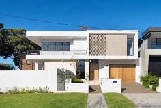  37 Yoorami Road Beverly Hills NSW 2209 Sophisticated in its design, exceptional in its uniqueness and playful in its functionality, this utterly striking and superbly crafted home represents flawlessness on a grand scale. With its clean, modern aesthetic and respectful, simple footprint, you can easily lose yourself in this sculptural work of art. Thanks to a basic, yet totally contemporary monochromatic palette and its state of the art appointments, this newly built 5 bedroom masterpiece expertly juxtaposes light, movement and texture to create a sense of allure and effortless appeal. In the main living space, soaring ceilings, unique architectural lines and bespoke design features, blend effortlessly to create light filled interiors as the day unfolds. Timber accents and statement pieces such as the curvaceous island bench in the kitchen, the somewhat elliptical niche carved in the ceiling above the designated dining area and the impressive yet unobtrusive staircase add warmth and a fundamental depth to the otherwise undefined interiors. The seamless indoor/outdoor flow invites you to savour time spent with family and friends as you retreat to the alfresco dining area and rear and fully fenced level yard. Upstairs, understated luxury is the order of the day with a master suite that features yet another sculptural piece - the wraparound balcony - as well as a generous walk-in robe and high-end his and hers ensuite. A further 3 bedrooms, 2 bathrooms and a spacious rumpus room complete the offering on this level. Exceptional in every way, this magnificent example of cutting edge architecture, offers a low maintenance lifestyle in a premium location. 