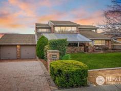  12 Catani Place Monash ACT 2904 $1,700,000 Surrounded by quality homes in a quiet cul-de-sac location you will find this grand family home boasting three living areas, four bedrooms and a large study. The extra-large door invites you into the grand foyer where you will admire the high ceilings, large staircase and views of the stunning backyard. The spacious formal lounge and dining is split level from the entry and opens onto the large wrap around covered deck which overlooks the gardens and inground pool. Flowing on from the dining room is the updated kitchen featuring a large stone island bench, excellent storage and bench space, gas cooking and instant boiling water tap. The kitchen opens onto the family room which also offers access out to the covered deck. Flowing on from the family room is a large rumpus room overlooking the pool and features its own bathroom with shower and toilet and a study space. Situated on the same level as the front door is the study/5th bedroom, powder room and the grand main bedroom with updated ensuite, walk-in robe and access out to its own deck/garden space. Upstairs you will find three generous bedrooms all with uninterrupted views of the Brindabellas and all with built-in robes. The stunning updated bathroom is also on this level and offers a double vanity, large shower and bath. The oversized double garage has internal access and remote roller doors. It is big enough to have two large cars and a workshop or gym area. Parking is not an issue thanks to the convenience of a second driveway with an extra-large carport. In the back yard you will find the wrap-around covered deck with Vergola roof, level lawn area and solar heated inground saltwater pool which features its own covered entertaining area. Storage for the pool is taken care of with a large pool shed. The rear garden also has a side deck off the laundry, large workshop/storage shed and irrigated gardens. Features: – Large formal lounge and dining room – Open plan kitchen family room – Updated kitchen with stone benches – Rumpus room with study/gym area and bathroom – Segregated main bedroom with walk-in robe and ensuite – Large bedrooms all with built-in robes – Study/5th bedroom next to front door – Oversized double garage with workshop area – Second driveway with large carport – Wrap-around covered deck and entertaining area – Solar heated saltwater inground pool with entertaining area – Pool shed and workshop in backyard – Landscaped gardens with irrigation system – EER 2.5 