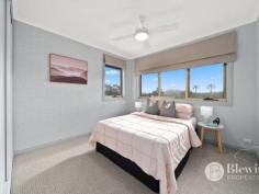  12 Catani Place Monash ACT 2904 $1,700,000 Surrounded by quality homes in a quiet cul-de-sac location you will find this grand family home boasting three living areas, four bedrooms and a large study. The extra-large door invites you into the grand foyer where you will admire the high ceilings, large staircase and views of the stunning backyard. The spacious formal lounge and dining is split level from the entry and opens onto the large wrap around covered deck which overlooks the gardens and inground pool. Flowing on from the dining room is the updated kitchen featuring a large stone island bench, excellent storage and bench space, gas cooking and instant boiling water tap. The kitchen opens onto the family room which also offers access out to the covered deck. Flowing on from the family room is a large rumpus room overlooking the pool and features its own bathroom with shower and toilet and a study space. Situated on the same level as the front door is the study/5th bedroom, powder room and the grand main bedroom with updated ensuite, walk-in robe and access out to its own deck/garden space. Upstairs you will find three generous bedrooms all with uninterrupted views of the Brindabellas and all with built-in robes. The stunning updated bathroom is also on this level and offers a double vanity, large shower and bath. The oversized double garage has internal access and remote roller doors. It is big enough to have two large cars and a workshop or gym area. Parking is not an issue thanks to the convenience of a second driveway with an extra-large carport. In the back yard you will find the wrap-around covered deck with Vergola roof, level lawn area and solar heated inground saltwater pool which features its own covered entertaining area. Storage for the pool is taken care of with a large pool shed. The rear garden also has a side deck off the laundry, large workshop/storage shed and irrigated gardens. Features: – Large formal lounge and dining room – Open plan kitchen family room – Updated kitchen with stone benches – Rumpus room with study/gym area and bathroom – Segregated main bedroom with walk-in robe and ensuite – Large bedrooms all with built-in robes – Study/5th bedroom next to front door – Oversized double garage with workshop area – Second driveway with large carport – Wrap-around covered deck and entertaining area – Solar heated saltwater inground pool with entertaining area – Pool shed and workshop in backyard – Landscaped gardens with irrigation system – EER 2.5 