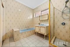  609 Barkly St West Footscray VIC 3012 $1,170,000 Step back in time and enjoy this four bedroom, solid brick house in all of its original glory. With the quirks of 70’s style and the space of a generous family home, there is a lot to love and endless possibilities to make this home your own. The home’s bedrooms are spacious with built-in robes, a large home office can be converted in to a fourth bedroom. The bedrooms are serviced by traditional 70’s bathroom with pastel blue tub, wall to ceiling feature tiles, vanity with storage, shaving cabinets, large linen cupboard, shower and separate toilet. Take your pick of two generous lounge spaces. The formal living area features a decorative ceiling and loads of 70’s charm, the second space opens to the home’s sunroom, making indoor/outdoor living effortless. Entertain in the light-filled, formal dining room with the same decorative ceilings and 70’s charm. The home’s kitchen is generous and features an abundance of storage along with, 900 gas cooktop, triple sink, retro feature tiles and plenty of bench space. There is ample space for a casual dining area in this room. The home is completed by a walk-through toilet and laundry with sink, ample storage and access to the sunroom. The property also features established front and rear gardens, veggie patch, shed, external kitchen and double garage. Located approximately 10kms from Melbourne’s CBD, an abundance of amenities are available at your doorstep. Barkly Street shops, restaurants and cafes, Whitten Oval, Central West Shopping Centre, Western Hospital, Footscray Market, West Footscray Train Station, schools, parklands and bus stops are just around the corner. Additional features: – 526.55m2 of land – Rear access via laneway – Security shutters throughout – Grand entry 