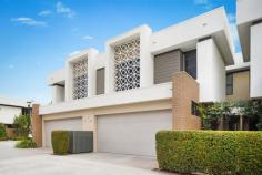 22/37 Sickle Avenue HOPE ISLAND QLD 4212 $795,000 Blending lifestyle, location and design with a high level of contemporary finishes is this immaculate, low-maintenance townhouse in Hope Island's exclusive gated estate of Waterville. Heightened ceilings crown a fluid, spacious and light-infused floor plan that spans 192m2 across two considered levels tailored for utmost luxury and liveability. The open living room, dining area and kitchen interact seamlessly with an undercover entertaining terrace and landscaped garden courtyard. The kitchen is appointed marbled stone surfaces, timber veneer accent cabinetry, European appliances including a gas cooktop, and a functional island dining bar. Stairs rise to a generous open study nook with an integrated desk and shelving near to the modern main bathroom and three carpeted bedrooms with built-in wardrobes. The private master bedroom is afforded a relaxation sitting zone, walk-in wardrobe and ensuite. The ground level also accommodates the full laundry, powder room and internal access to the double garage with the convenience of a storeroom. Waterville, an intimate and secure gated waterfront estate exclusive to Hope Island, comprises 24 designer townhouses and a host of residents' only facilities including a pool, sun lounging terrace, undercover barbecue and alfresco dining area, gymnasium, lounge, onsite management and boardwalk access. Waterville is within minutes of The Hope Island Shopping Centre and Hope Island Marketplace as well as parks, medical facilities, sporting clubs, and the boutique shops, cafes, marina and restaurants of Sanctuary Cove. * Designer modern dual-level townhouse of 192m2 * Gated waterfront estate with residents' facilities * Quality kitchen has stone surfaces and gas cooktop * Under-roof alfresco entertaining courtyard terrace * Study nook has integrated desk, storeroom in garage * Master bedroom with ensuite and walk-in wardrobe * Gymnasium and Onsite Management * Sun Lounging Terrace with Stunning Pool 