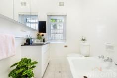  2/20 Wolseley St Drummoyne NSW 2047 Peaceful and welcoming, this elegant two-bedroom apartment in a refined Art Deco building blends classic style with light-filled living spaces and an easy-care layout. Conveniently located on the ground floor, which enjoys direct access to a leafy courtyard, while its elevated position delivers district views. Beautifully presented heritage features, such as high ceilings, picture rails and timber floors, are complemented by thoughtful modern upgrades, including air conditioning and carpeting in bedrooms. In addition to the spacious guest bedroom is a king-sized master featuring built-in robe and adjoining sunroom with a bright north-east outlook. Ideally situated for easy access to the CBD and bayside recreation, only 350m to ferry and bus routes, 600m to Five Dock Bay Esplanade. • Charming two-bedroom apartment in a quiet, east Drummoyne complex • Sunlit lounge featuring tiled fireplace, wide windows, and district views • Full-sized gas kitchen with plenty of storage, subway tiling, and Bosch dishwasher • Modern bathroom featuring designer vanity and combined shower/bath • Expansive master with dual built-in robe, air con and ceiling fan • Large sunroom with potential use as home office, art studio, or study • Double guest room including built-in robe, air con and ceiling fan • Internal laundry offers room for washer, dryer, and storage • Single space lock-up garage with additional storage space 