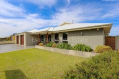  45 Ormonde Street Bandy Creek WA 6450 $1,100,000 Bandy Creek – High end living puts this fabulous rendered brick and colorbond, architecturally designed home in a class of its own. Upon entry you will be impressed with the attention to detail this property has to offer. There are 3 bedrooms, (all double in size) – the master suite with deluxe ensuite and custom designed shelving/racking to walk in robe plus office. The huge open plan living seamlessly flows through to indoor/outdoor living room with built in, Jarrah/blackbutt and granite bar plus built-in BBQ. The full height windows draw to an apex where design and angles allow for solar energy efficiency. Gleaming Blackbutt plank flooring to high traffic areas, creates a striking eyeline drawing up to designer kitchen with a mixture of Jarrah and Granite fit-out to island and servery benches. Here you’ll find Miele appliances, Hafele pull-out pantry, dishwasher and rainwater plumbed to kitchen sink. There is a separate home theatre room with dual access from bi-fold and personal doors adjoining the indoor/outdoor living. Porcelain floor to ceiling tiling to both bathrooms and powder room, double shower and spa bath to ensuite, quality Luxaflex window treatments with automated silhouette blinds to games room and window shutters in all bedrooms. Ducted, reverse cycle airconditiong, walk-in storage room, ample linen storage and built-in ironing station in laundry plus Valet- IN-wall vacuum system throughout the home. Double garage with separate remote tilt doors UMR plus large 6m x 9m colourbond garage easily accessed from automated gate off 2nd street entry. The neat external grounds are complete with a mixture of paving and reticulated lawn areas. Inbuilt Sonos, 3 zoned, audio sound system plus residential VIP intercom kit with CCTV camera/alarm system. The home, with a total of 397m2 of living, is located on a 1004 sqm corner lot and is less than 1km to Castletown Quays foreshore. 