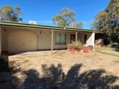  25 Van Senden Avenue Gillen NT 870 $430,000 - $470,000 Located near schools, shops, and Araluen Park this 3 bedroom 2 bathroom home has a lot of potential! The extensively wide driveway is paved in slate stone leading up to a fully tiled front patio and a coloured sandstone flowerbed. The Front Boundary fence is constructed from Rail Sleepers from the Ghan Railway Line. The good size lounge/dining area offers split system air-conditioning and a ceiling fan for all-year-round comfort. Adjacent to the kitchen provides ample bench and cupboard space with gas cooking and a large window with a view of the backyard. Other large windows throughout allow natural light to flow through the home. Located down the hallway the first and second bedrooms are tiled with free-standing wardrobes while the third bedroom offers a built-in wardrobe and ceiling fan. The main bathroom includes a full-size bath and a separate enclosed shower with a separate toilet in the large laundry. The Carport is fully enclosed with all Electric fittings and Electric Roller Door, it includes a fully tiled Shower, Toilet, and Laundry The backyard is mostly paved in slate stone with a small maintainable grass area and a reticulated vegetable garden. The rear area has secure private fencing with a gateway to Underdown Street. Main Features Include: – 3 bedrooms, 2 bathrooms – Good size living and dining area with split system air-conditioning – Split system air-conditioning – Solar hot water – Garage with electric roller door – Large driveway – fit up to 4 cars – Electrical power supply is underground 