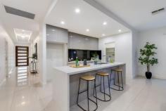 5 Webb St Lightsview SA 5085 Impeccably stylish in both feature and form, this sparkling modern family home in the heart of Lightsview is an absolute suburban stunner. Spilling with designer finishes from front to back, enter to a wide hallway where large format porcelain tiles flow past a large light-filled formal lounge and into a sprawling open-plan living and dining seamlessly extending to an all-weather alfresco for the ultimate in indoor-outdoor entertaining. The stone-wrapped chef's kitchen gleams with high gloss soft-closing cabinetry and splashback, waterfall island and breakfast bar, walk-in pantry and stainless appliances to ensure no matter if you're cooking nightly meals for the family or hosting friends for delicious dinners, you'll be doing it in stress-free style. Versatile living and thoughtful interior design are part-and-parcel of 5 Webb Street's family-friendly footprint which sees a privately positioned and generous master bedroom complete with large walk in robe and deluxe ensuite located at the front of the home, while three additional good-sized bedrooms all with built-ins and soft carpets occupy the back. The luxurious main bathroom is central to the home and features superb floor-to-ceiling tiling, separate shower and sumptuous bath as well as separate WC for extra family convenience, while ducted AC throughout keeps everyone cosy and comfortable year-round. With a wonderful lifestyle on offer, both inside and out, a property such as this beautifully positioned so close to a host of great amenities ranging from pristine leafy reserves and walk trails, local cafés for the perfect morning coffee, handy public transport to zip you into the city and just a 3-minute drive to Hillcrest Primary for quick and easy morning commutes with the kids - this stunning, feature-packed designer home promises to be the start of something special. THINGS WE LOVE • Stunning and spacious open-plan kitchen, dining and living with large formal lounge for excellent entertaining options • Gleaming designer kitchen with stone-topped waterfall island, gloss cabinetry, large WIP and stainless appliances KEY FEATURES • Decadent soft-carpeted master bedroom with generous WIR and deluxe ensuite with floor-to-ceiling tiling • 2 large bedrooms and good-sized 3rd bedroom, all with soft-carpets and BIRs • Central main bathroom featuring stylish floor-to-ceiling tiling, separate shower and relaxing bath, and separate WC • Family-friendly laundry • Ambient LED downlights and ducted AC throughout for year-round comfort • Tiled all-weather alfresco, high private fencing and neat stretches of lawn • Double garage with auto panel lift door and aggregate concrete driveway LOCATION • Close to pristine local parks and scenic walking trails • A quick 3-minutes to Hillcrest Primary and zoned for Roma Mitchell Secondary College • 5-minutes in each direction to Northgate and Greenacres shopping precincts for all your everyday needs 