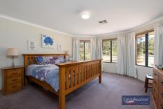  140 Samuel St Mount Helena WA 6082 $749,000 Three living zones, including a central open plan, a junior wing with an activity space and a large multi-purpose games room fashion a big family home with the additional benefits of a separate study, north-facing outdoor living and a rear boundary shared with the green open space of a reserve. A tranquil setting, a welcoming floorplan and a fully fenced backyard with a powered workshop set the stage for a beautiful life in the pretty Hills town of Mount Helena. 5 beds, 2 baths + study 2000-built brick & iron 3 separate living zones Central open-plan design Junior wing activity room Ducted Reverse Air Con Dome roof n-face patio Dbl garage with storage ½-acre adjoining reserve Tranquil family haven The heart of this family home is a sweeping expanse of open-plan living with timber-look floors, a slow-combustion fireplace and north-facing windows. A spacious kitchen, French doors leading from the meals area to a paved patio and a shoppers’ entry from the two-car garage fashion a practical and welcoming family hub. The kitchen features a large benchtop with an integrated breakfast bar, a two-door pantry ad a dishwasher, an electric oven and grill and a 4-burner gas hob. Adjoining the central living space is a substantial multi-purpose games room, an ideal entertaining area, formal lounge, or dining room. A central activity room in the junior wing gives young children a dedicated playroom and teens a retreat with a degree of autonomy. Four good-sized bedrooms with built-in or walk-in robes, a family bathroom with tub, shower and vanity and a separate WC complete the layout in the junior wing. The main bedroom sits at the front of the floor plan along with a separate study – a bright and welcoming space that would make a great nursery or a parents’ sitting room. A large bay window brings floods of natural light to the main bedroom, a spacious room with a walk-through robe, ensuite and separate powder room, which is also accessible from the home’s central hallway. Towards the rear of the level fully fenced lot is a powered and plumbed workshop with drive-in access at the property’s southern boundary. The green open space of a reserve at the rear boundary adds to the sense of freedom offered by a ½-acre lot. Minutes from the centre of Mount Helena township and a short drive from the bustling village of Mundaring, this home is ideally located for schools, sports and kilometres of walking and riding along the Heritage trail. 