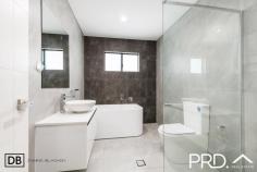  36a Dernancourt Parade Milperra NSW 2214 $1,198,000 As new and created to exacting standards, this striking duplex provides an exceptional family home designed for effortless living and entertaining. Beautifully appointed and finished to perfection, it reveals a spacious open plan living/dining area enjoying a seamless transition to superb alfresco entertaining and a child-friendly level backyard. Property Features: - Striking entrance foyer. - Open plan living/dining bathed in natural light. - Seamless flow to covered alfresco with outdoor kitchenette. - Sleek stone kitchen with huge breakfast bar. - Downstairs bedroom and bathroom (great for older guests). - 4 bedrooms upstairs; main with ensuite. - Deluxe bathrooms with freestanding bath. - Ducted air-conditioning, engineered timber floors and high ceilings. - Beautiful, landscaped backyard. 