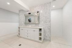  18 Hereford Close KINGSHOLME QLD 4208 Nestled on a secluded 4,968sqm block in the luxurious Montego Hills Estate, surrounded by lush native bushland, lies this grand and opulent 567sqm custom design residence. Built in 2018, this luxurious abode offers ample space and an array of lavish features to cater for every need. As you enter the property, you are greeted by the grandeur of the main entrance, which flows throughout both storeys and culminates with a ceiling that soars to over 4 meters high. The large proportions of the residence are evident in every room, making it perfect for both family living and entertaining guests. The property boasts 6 bedrooms, all with built-in wardrobes/walk-in wardrobes, providing ample storage space. The 2 main bedrooms, one upstairs and one downstairs, are the epitome of luxury and both feature walk-in wardrobes and ensuites, allowing for complete privacy and convenience. The home features 3 bathrooms + a powder room, all with Caesarstone benchtops and Carrara marble features, exuding luxury and opulence as well as 3 separate living areas, each designed to provide the ultimate in comfort and relaxation. The large open plan kitchen, lounge, and dining room features a faux fireplace (gas), perfect for chilly evenings. The media room is designed with acoustic insulation in the walls, providing the perfect space for movie nights with family and friends. The large multi-purpose room or 7th bedroom with built-in cupboards is perfect as a guest room or even a home office. The gourmet kitchen is a chef's dream, equipped with Caesarstone bench tops, a 900mm gas cooktop, electric oven, dishwasher, ducted range hood and Carrara marble splashback. The butler's pantry and study nook are off the kitchen, providing ample space for meal preparation and storage. The separate laundry room also features Caesarstone bench tops and ample storage and cupboards, making laundry a breeze. The property also features a 22,500L in-ground rainwater tank, Krystel Kleer (BioCycle) wastewater treatment system, insulation in all internal and external walls, floor, and ceiling, and acoustic insulation in between storeys. The property is also equipped with security doors and screens, fly screens, ceiling fans, and LED downlights throughout. It has a bottle gas hot water unit and is NBN connected with data points in every room hardwired for internet connection. This residence is truly a masterpiece, seamlessly blending luxury and functionality. With its grand proportions, spacious living areas, and an array of luxurious features, this property is the epitome of luxury living. Features: • 567sqm custom designed residence on a secluded 4,968sqm block • Built in 2018, with grand entrance and high ceilings • 6 bedrooms with walk-in robes and ensuite in main bedrooms • 3 bathrooms (plus a powder room) with Caesarstone benchtops and Carrara marble features • 3 separate living areas and a gourmet kitchen • Double lock-up garage and separate laundry • In-ground rainwater tank, wastewater treatment system and insulation throughout • Security features, LED downlights and Bottle gas hot water unit • NBN connected and data points in every room • 19.61kw Solar System 