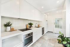  51 Australia St Camperdown NSW 2050 With its leafy park side location, abundance of great eateries, and easy transport options this charming three-bedroom terrace delivers a fantastic inner-city lifestyle. Beautifully presented, the stylish interiors blend thoughtful upgrades with pristine heritage features to create a warm and welcoming home. Providing plenty of space for young professionals and growing families alike, the generous lower level includes lounge, separate dining area, and stunning designer kitchen. While the bright and sunny upper level has two guest bedrooms, plus master with an ornate balcony that overlooks Camperdown Park. Entertain friends and family, or simply relax, in the private and spacious courtyard framed by established greenery. A convenient Camperdown location means vibrant King St, Newtown train station, CBD buses, and local parks are all within a 1km radius. • Delightful heritage three-bedroom home in a prized end-of-terrace position • Light-filled layout with separate lounge and dining rooms, both with original fireplaces • Sleek and modern kitchen featuring self-cleaning electric oven, Bosch dishwasher • Cleverly concealed laundry with room for washing machine and separate dryer • Large designer bathroom with deep bath and combined waterfall shower • Two bright and sunny guest bedrooms, one with built-in robe and storage • Large master bedroom featuring original fireplace, built-in robe, and private balcony • Timber flooring throughout. Ceiling fans. Period features. Security grills • Large courtyard accessible from kitchen. Rear lane access and parking. 