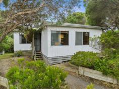  5 Harbour View Sandy Point VIC 3959 $750,000-800,000 Set on approx. 688m2 of land with sheltered rear garden and magnificent tree top height entertaining deck. Much loved by the current owners and now ready for a new family to enjoy. Well maintained both inside and out with easy care external cladding. Living room with wood look gas heater, polished flooring and delightful treed outlook. Retro kitchen with electric stove and breakfast bar to the adjoining meals area. 3 bedrooms, modern family bathroom with laundry facilities. Bore water and tank for drinking water. Under home storage space. Parking for multiple cars. Just 3 minutes walk from beach access and 6 mins stroll to the cafe, general store and tennis courts. Come and discover this picturesque coastal location where the country meets the coastline. 