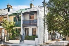  51 Australia St Camperdown NSW 2050 With its leafy park side location, abundance of great eateries, and easy transport options this charming three-bedroom terrace delivers a fantastic inner-city lifestyle. Beautifully presented, the stylish interiors blend thoughtful upgrades with pristine heritage features to create a warm and welcoming home. Providing plenty of space for young professionals and growing families alike, the generous lower level includes lounge, separate dining area, and stunning designer kitchen. While the bright and sunny upper level has two guest bedrooms, plus master with an ornate balcony that overlooks Camperdown Park. Entertain friends and family, or simply relax, in the private and spacious courtyard framed by established greenery. A convenient Camperdown location means vibrant King St, Newtown train station, CBD buses, and local parks are all within a 1km radius. • Delightful heritage three-bedroom home in a prized end-of-terrace position • Light-filled layout with separate lounge and dining rooms, both with original fireplaces • Sleek and modern kitchen featuring self-cleaning electric oven, Bosch dishwasher • Cleverly concealed laundry with room for washing machine and separate dryer • Large designer bathroom with deep bath and combined waterfall shower • Two bright and sunny guest bedrooms, one with built-in robe and storage • Large master bedroom featuring original fireplace, built-in robe, and private balcony • Timber flooring throughout. Ceiling fans. Period features. Security grills • Large courtyard accessible from kitchen. Rear lane access and parking. 